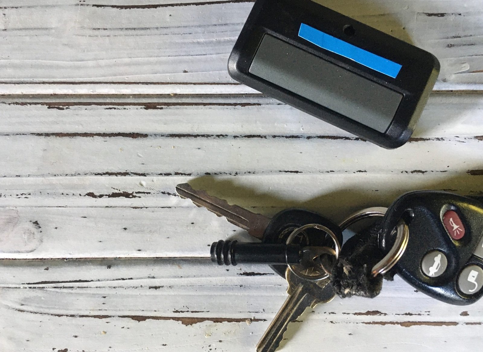 Keys and garage door opener on white background Keys and garage door opener on white background